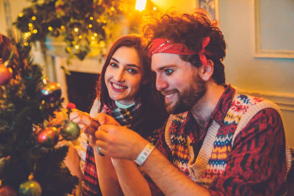 A couple smile as they placed their home made Christmas baubles on the tree.